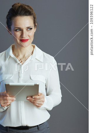 pensive elegant 40 years old business woman isolated on grey pensive elegant 40 years old business woman isolated on grey 109396122