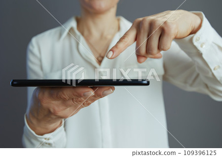 Closeup on woman worker in white blouse isolated on grey Closeup on woman worker in white blouse isolated on grey 109396125