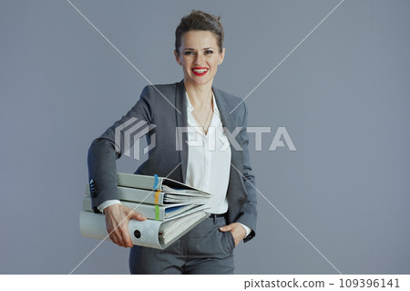 happy stylish female worker isolated on gray background 109396141