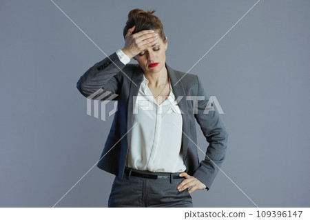 stressed modern woman worker isolated on grey background 109396147