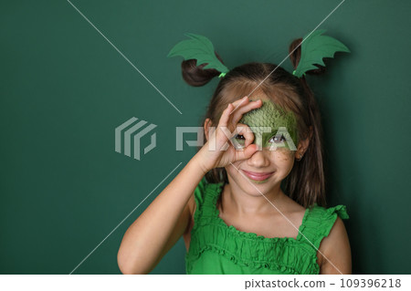 A beautiful girl dressed up as a dragon makes a gesture with her fingers ok. The symbol of the 2024 new year according to the Eastern calendar A beautiful girl dressed up as a dragon makes a gesture with her fingers ok. The symbol of the 2024 new year according to the Eastern calendar 109396218