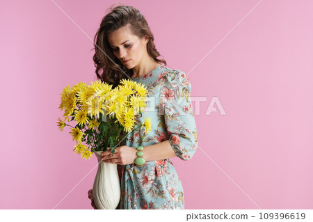 young female with long wavy brunette hair on pink 109396619