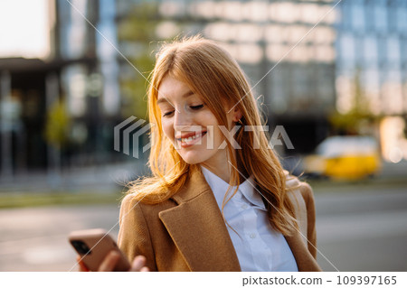 Professional Woman with Electric Blue Blazer and Layered Hair Smiling in City Street Portrait 109397165