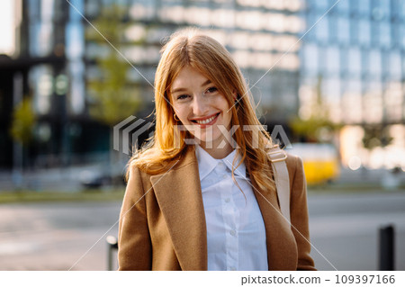 Professional Portrait of a Smiling Fashion Model in Formal Attire with Layered Hair and Fashion Accessories 109397166