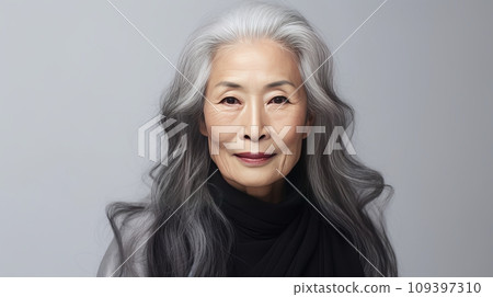 Elegant, smiling, elderly, chic Asian woman with gray long hair and perfect skin, on a gray background, banner Elegant, smiling, elderly, chic Asian woman with gray long hair and perfect skin, on a gray background, banner 109397310