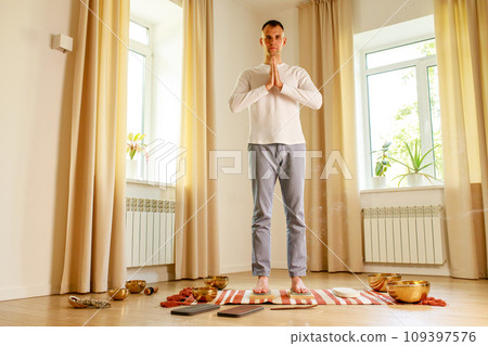 morning yoga practice with sadhu nails. mans foot on the wooden desk with sharp metal nails morning yoga practice with sadhu nails. mans foot on the wooden desk with sharp metal nails 109397576