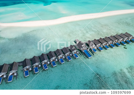 stunning blue ocean and sandy lux hotels on water top drone aeral view Maldives beach copyspace for text stunning blue ocean and sandy lux hotels on water top drone aeral view Maldives beach copyspace for text 109397699