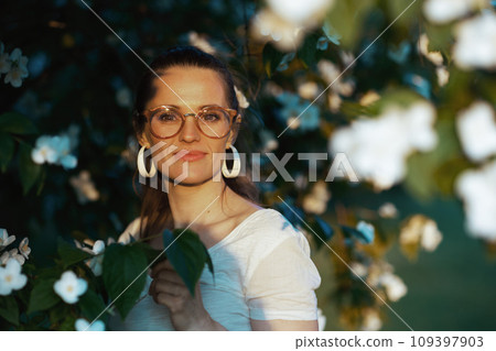 Portrait of happy modern woman in white shirt with eyeglasses 109397903
