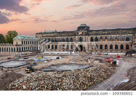 Dresden Zwinger palace king inner courtyard under reconstruction and renovation with dramatic sunset sky background. German architecture landmark building garden repair landscaping 109398601