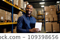 Businessman standing in his fabric warehouse and working with tablet PC. 109398656