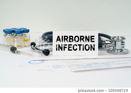 On the medical documents there is a stethoscope, syringe and a business card with the inscription - AIRBORNE INFECTION 109398729