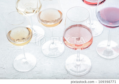 Wine glasses at a tasting. Rose, red, and white wine, drinks on a table 109398771