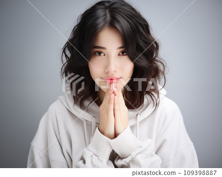 A woman with both hands together A woman with both hands together 109398887