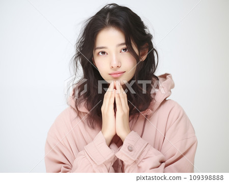 A woman with both hands together A woman with both hands together 109398888