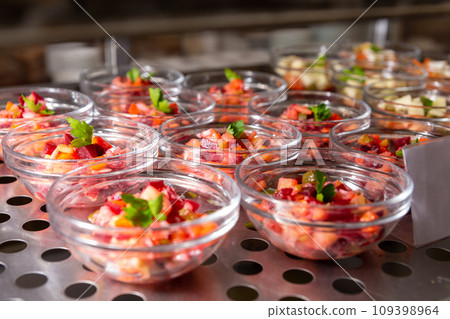 Plates with various pastries in the cafeteria window. 109398964