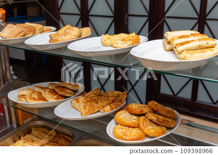 Plates with various pastries in the cafeteria 109398966
