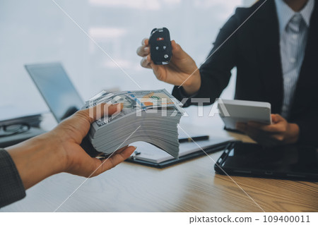 Salesman send key to customer after good deal agreement, successful car loan contract buying or selling new vehicle. 109400011