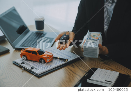 Salesman send key to customer after good deal agreement, successful car loan contract buying or selling new vehicle. 109400023