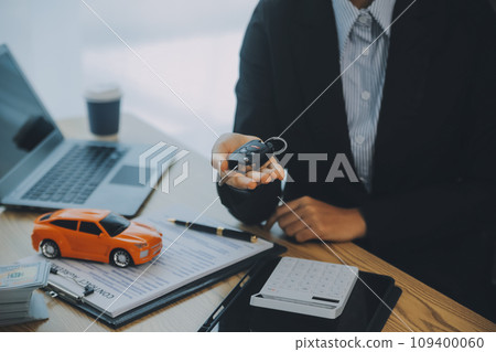 Salesman send key to customer after good deal agreement, successful car loan contract buying or selling new vehicle. Salesman send key to customer after good deal agreement, successful car loan contract buying or selling new vehicle. 109400060