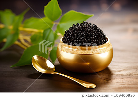 Closeup of natural black caviar in golden bowl on black background, texture of luxury fresh sturgeon caviar macro photo. Closeup of natural black caviar in golden bowl on black background, texture of luxury fresh sturgeon caviar macro photo. 109400950