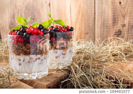Two fruit cocktails. Cocktails with berries and granola. Fresh berries in glasses. 109401077