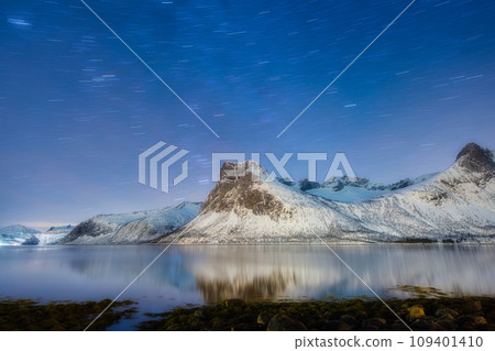 Mountains and starry night sky, Senja islands, Norway. Reflection on the water surface. Mountains and starry night sky, Senja islands, Norway. Reflection on the water surface. 109401410