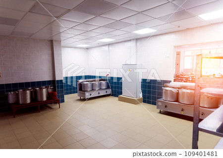 Industrial kitchen in a school restaurant with professional equipment and pans 109401481