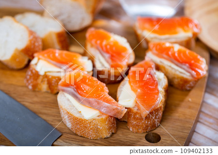 Appetizer canape of baguette with smoked salmon Appetizer canape of baguette with smoked salmon 109402133