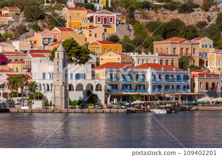 Multi-colored facades of houses in the village Symi on a sunny day. Multi-colored facades of houses in the village Symi on a sunny day. 109402201