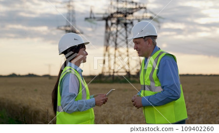 Electricians with tablet approve innovative technology of power generation plant Electricians with tablet approve innovative technology of power generation plant 109402260