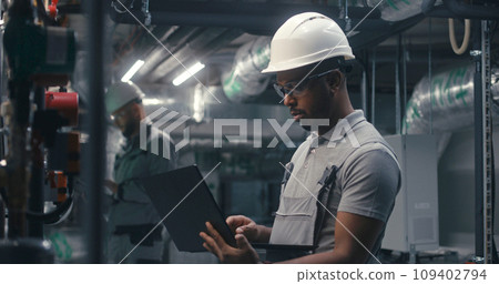 African American technician specialists checks piping system African American technician specialists checks piping system 109402794