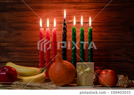 Happy Kwanzaa. Seven candles red, black and green on wooden background. Happy Kwanzaa. Seven candles red, black and green on wooden background. 109403035