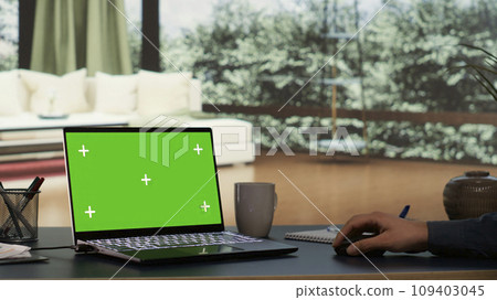Rich entrepreneur rests at his outstanding alpine villa, viewing greenscreen projection on his laptop. International director interacts on pc with blank chromakey display, luxurious daily living. Rich entrepreneur rests at his outstanding alpine villa, viewing greenscreen projection on his laptop. International director interacts on pc with blank chromakey display, luxurious daily living. 109403045
