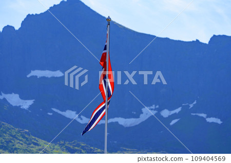 Norwegian National Flag Fluttering in Front of Spectacular Mountain Landscape 109404569