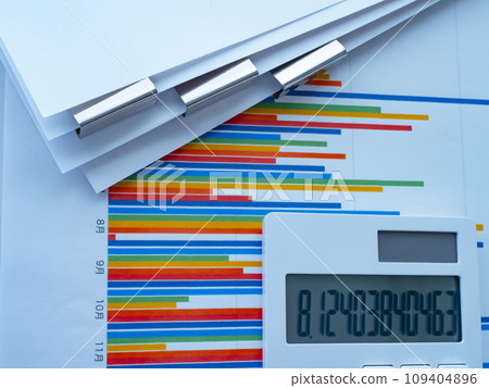 Graphs, documents and calculator on the table Graphs, documents and calculator on the table 109404896