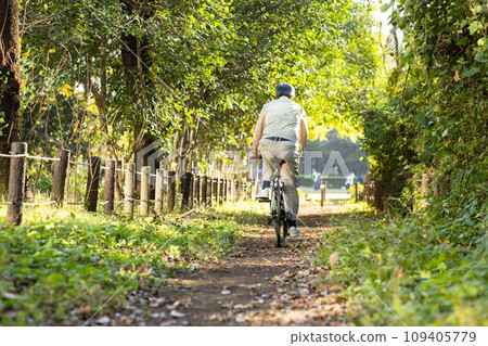 Senior man taking a walk in the park 109405779
