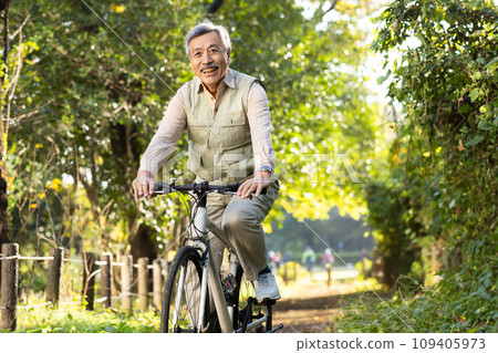 Senior man taking a walk in the park 109405973