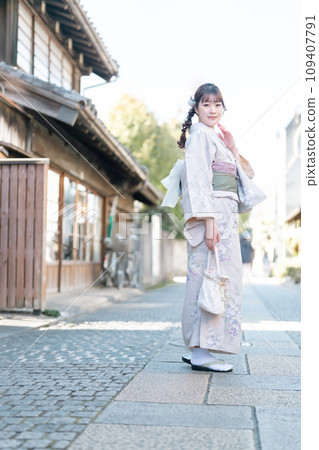 一位年輕女子穿著和服在城裡散步 109407791
