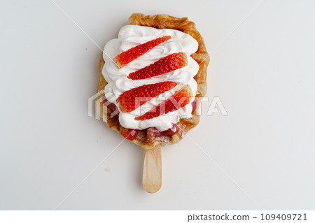 croissant waffles decorated with whipped cream, strawberries, nuts, banana and blueberries croissant waffles decorated with whipped cream, strawberries, nuts, banana and blueberries 109409721