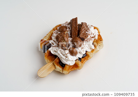 croissant waffles decorated with whipped cream, strawberries, nuts, banana and blueberries croissant waffles decorated with whipped cream, strawberries, nuts, banana and blueberries 109409735