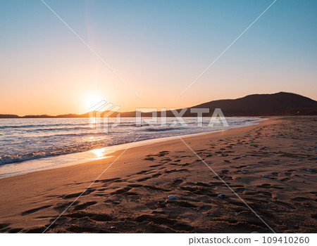 Sunset on the beach. Orange and golden sunset sky calmness tranquil relaxing sunlight summer mood. 109410260