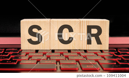 scr written on wooden cubes on the laptop keyboard 109411004