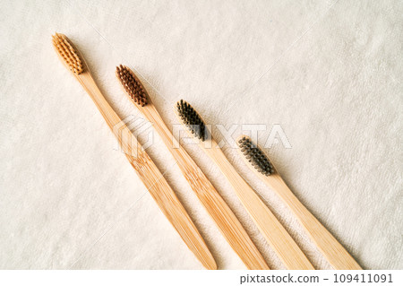 Toothbrushes on a white terry towel. 109411091