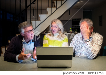 Joyful Engagement over a laptop Among Senior Friends 109411758