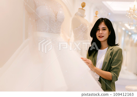 Female bridal store owner work in wedding studio shop.  109412163