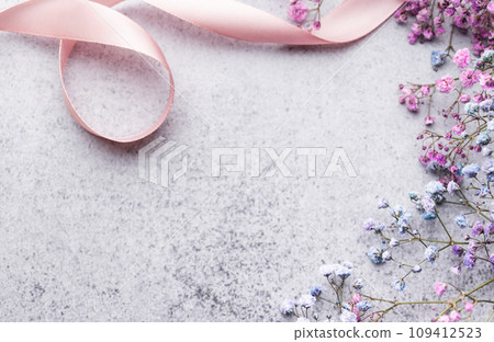 Colored gypsophila flowers on concrete background Colored gypsophila flowers on concrete background 109412523