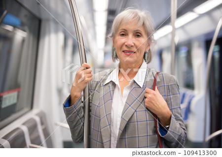 Mature woman inside subway train 109413300