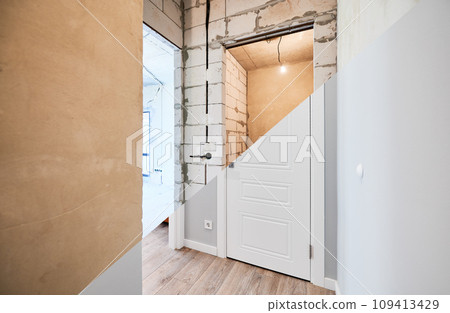 Old apartment with brick walls and new renovated flat doors, room and elegant interior design. Comparison of apartment before and after restoration. Home renovation concept. Old apartment with brick walls and new renovated flat doors, room and elegant interior design. Comparison of apartment before and after restoration. Home renovation concept. 109413429