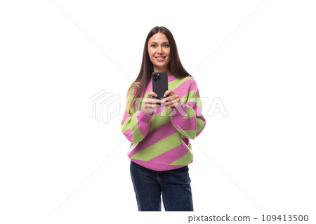 young slender caucasian woman with straight black hair dressed in a striped pink pullover young slender caucasian woman with straight black hair dressed in a striped pink pullover 109413500