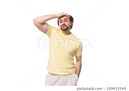 young brutal brunette man in a t-shirt feels a headache on a white background with copy space 109413549
